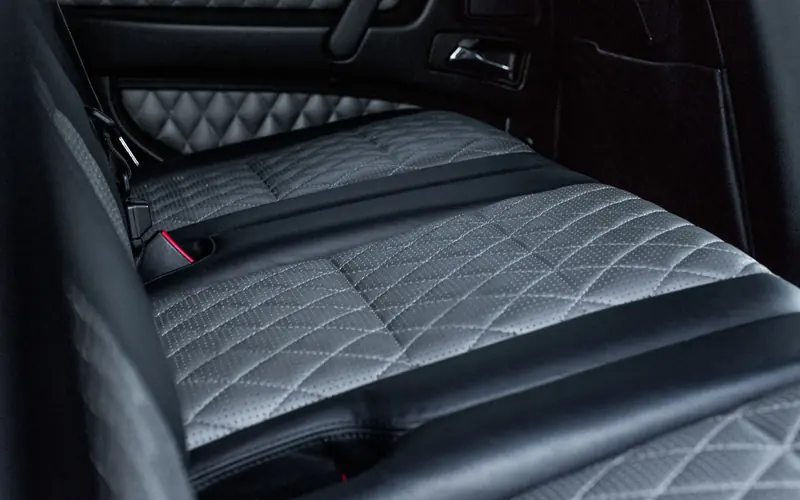 Black quilted leather rear seat inside a car